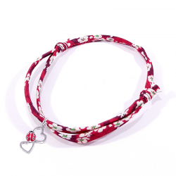 bracelet en tissu liberty rouge avec coccinelle posée sur deux cœurs en argent